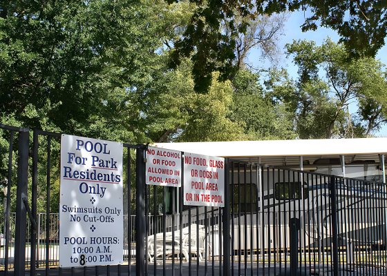 Swimming pool with fence and pool rules sign